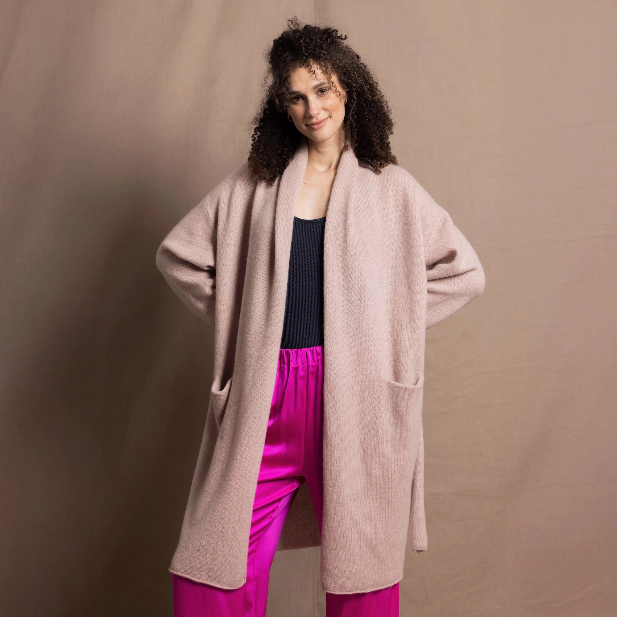 a woman wears a 100% pure cashmere luxury sweater cardigan wrap over silk trousers