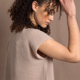 a woman wears luxury cashmere tee sweater in beige