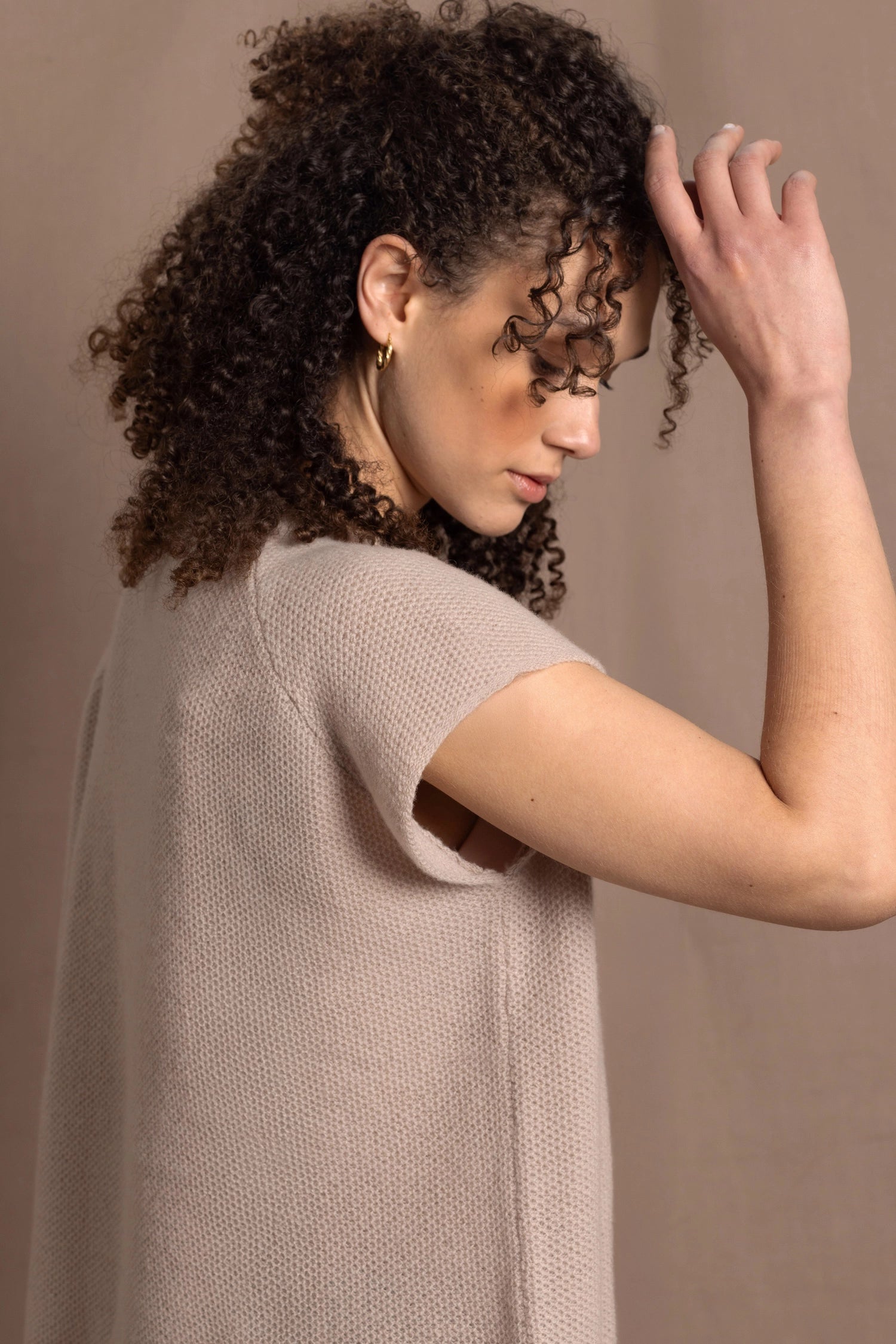 a woman wears luxury cashmere tee sweater in beige