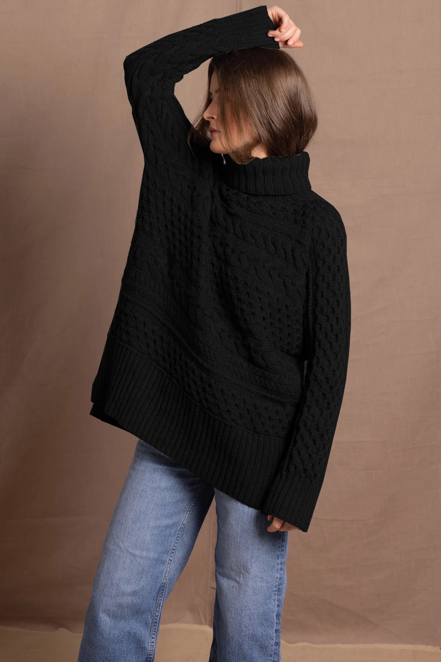 Lady wears pure cashmere aran sweater from Ireland in black