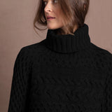 Lady wears pure cashmere aran sweater from Ireland in black