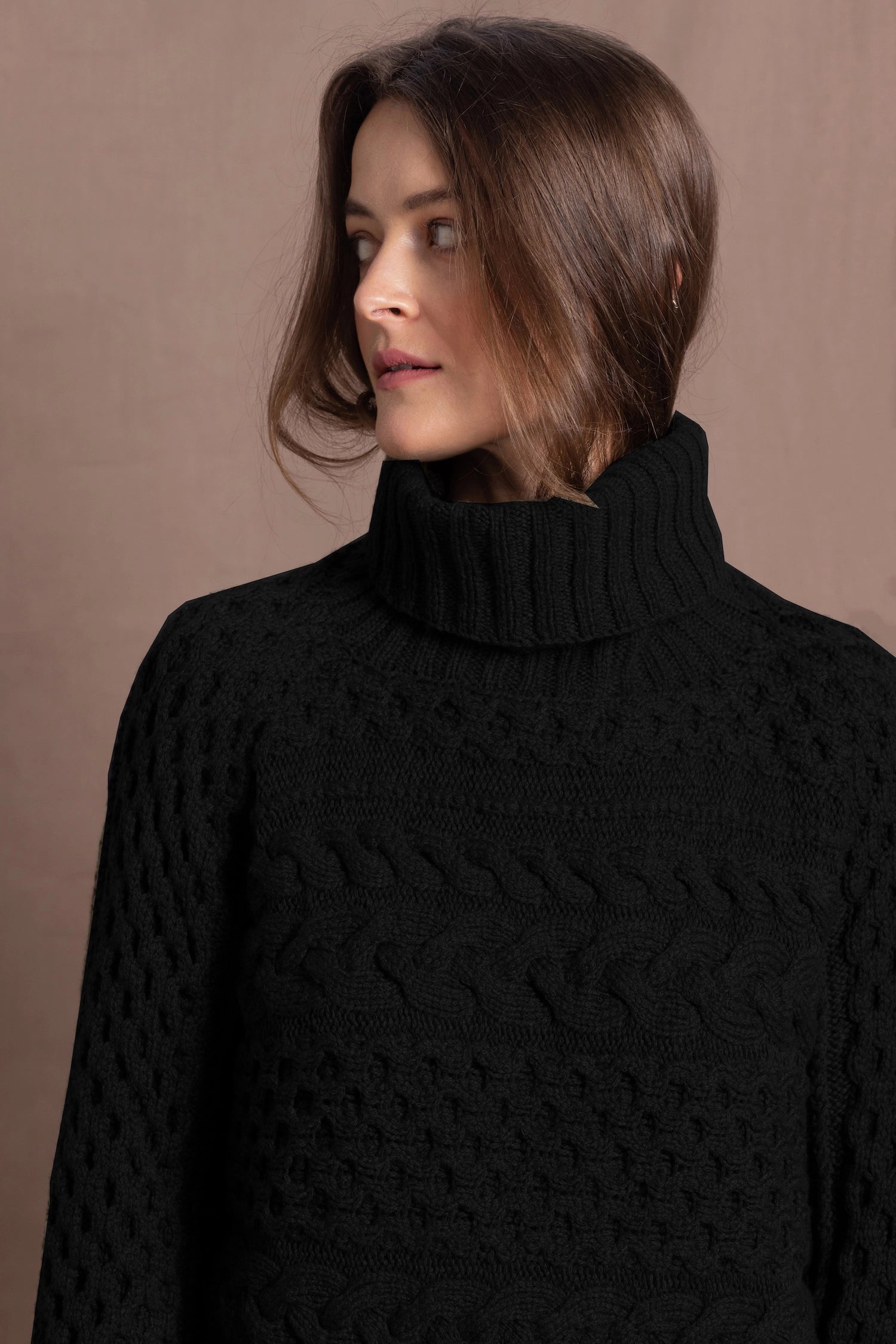 Lady wears pure cashmere aran sweater from Ireland in black