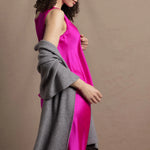 Lady wears large cashmere wrap shawl in Grey against bright pink silk clothing