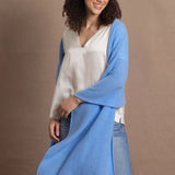 Lady wears large cashmere wrap shawl in cerulean blue