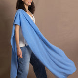 Lady wears large cashmere wrap shawl in cerulean blue
