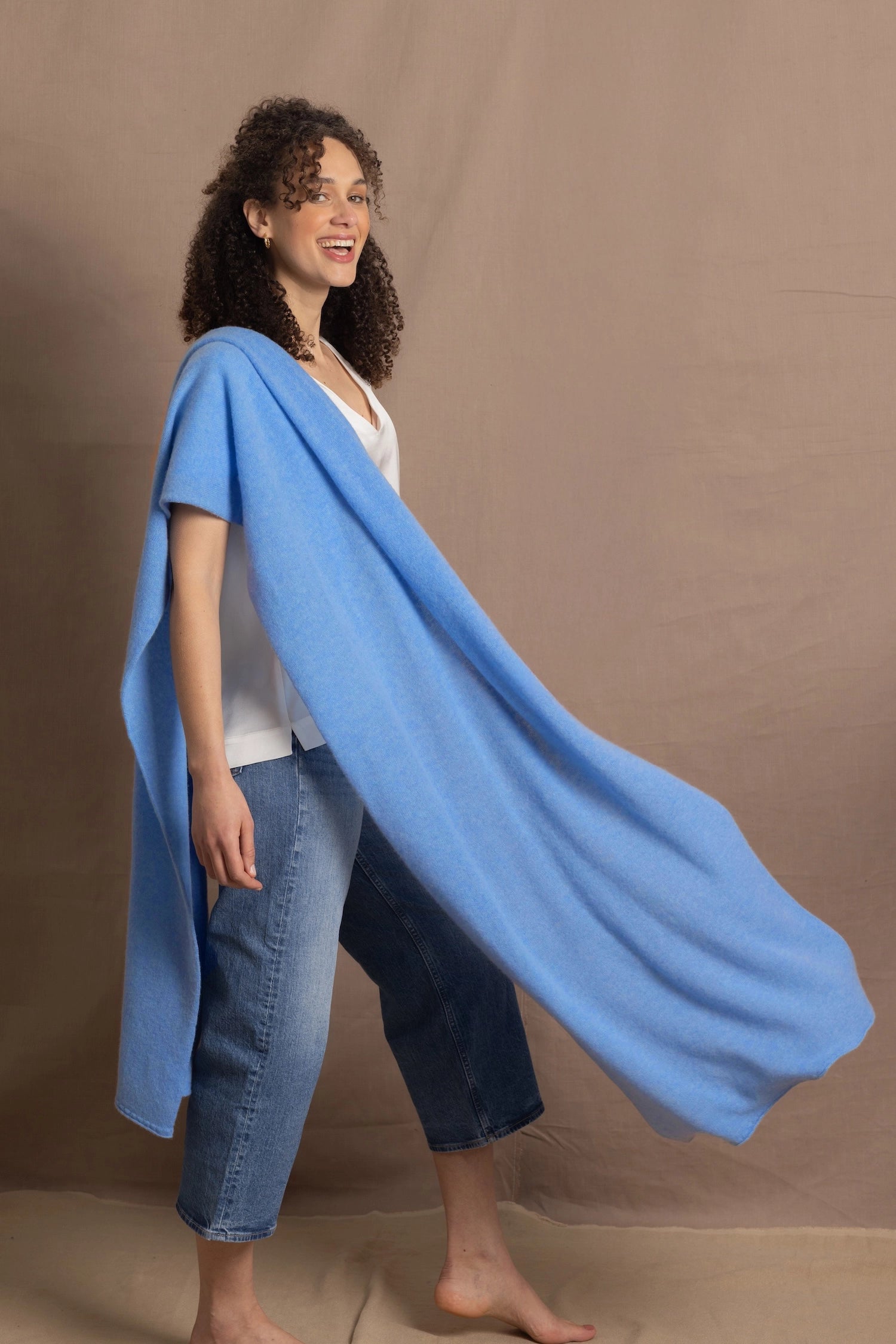Lady wears large cashmere wrap shawl in cerulean blue