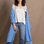 Lady wears large cashmere wrap shawl in cerulean blue