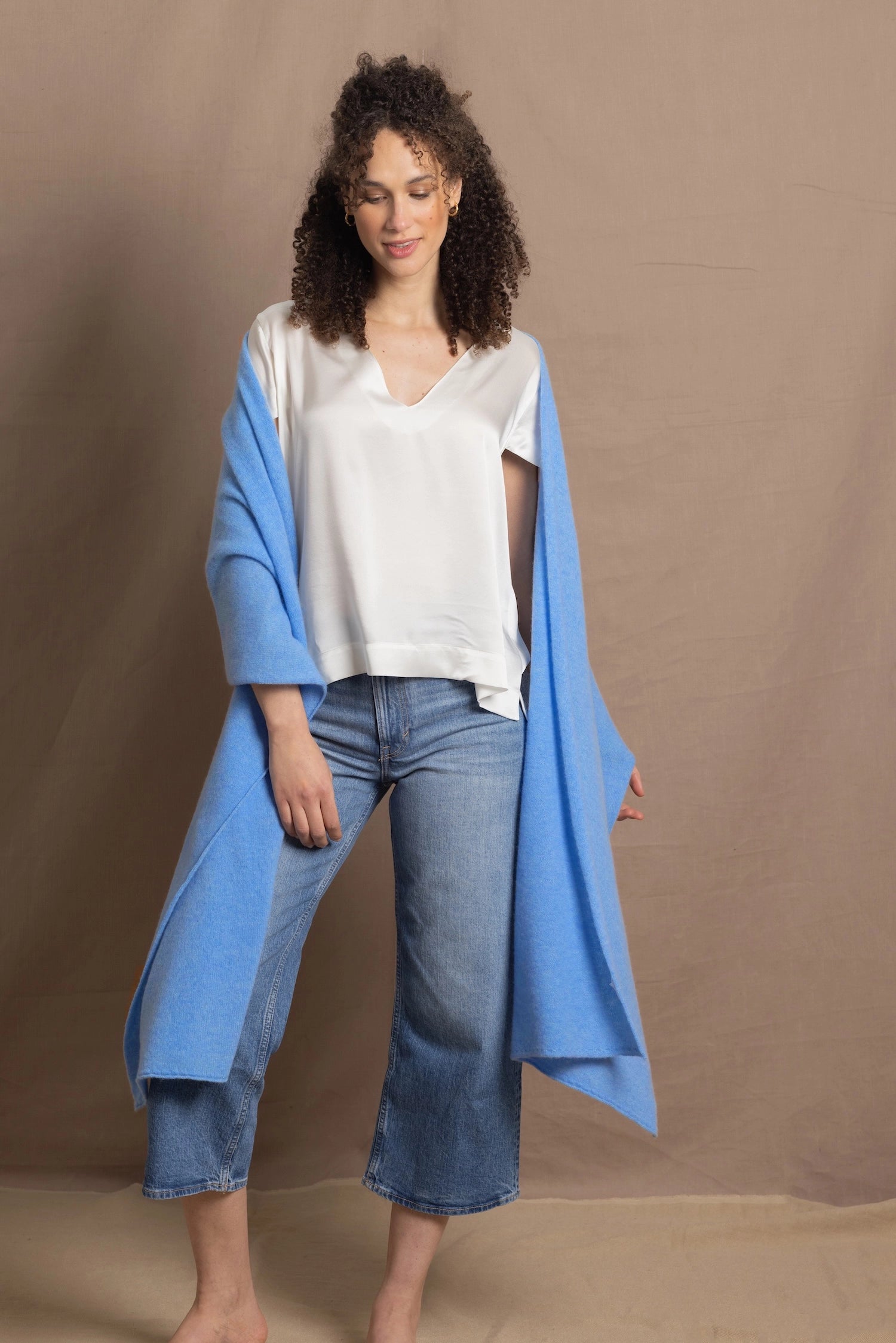 Lady wears large cashmere wrap shawl in cerulean blue