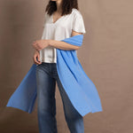 Lady wears large cashmere wrap shawl in cerulean blue