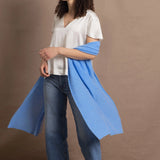 Lady wears large cashmere wrap shawl in cerulean blue