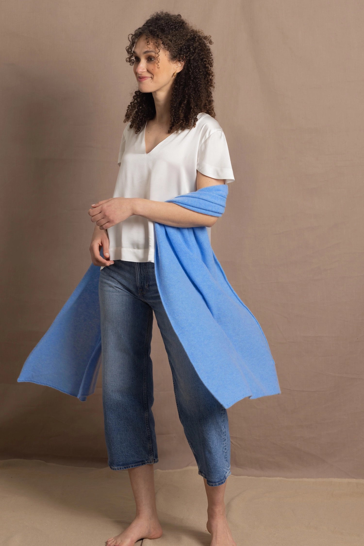 Lady wears large cashmere wrap shawl in cerulean blue