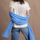 Lady wears large cashmere wrap shawl in cerulean blue