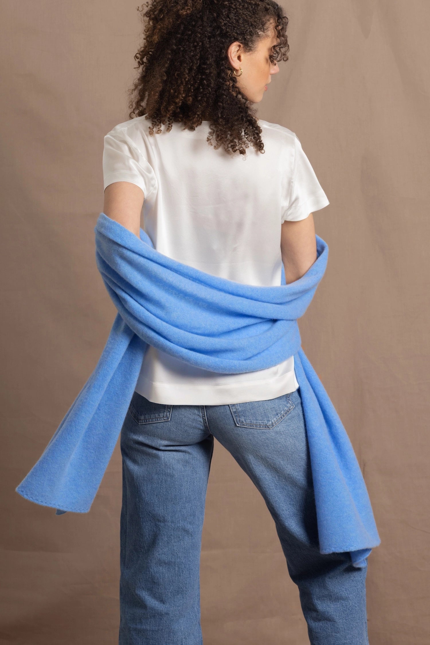 Lady wears large cashmere wrap shawl in cerulean blue