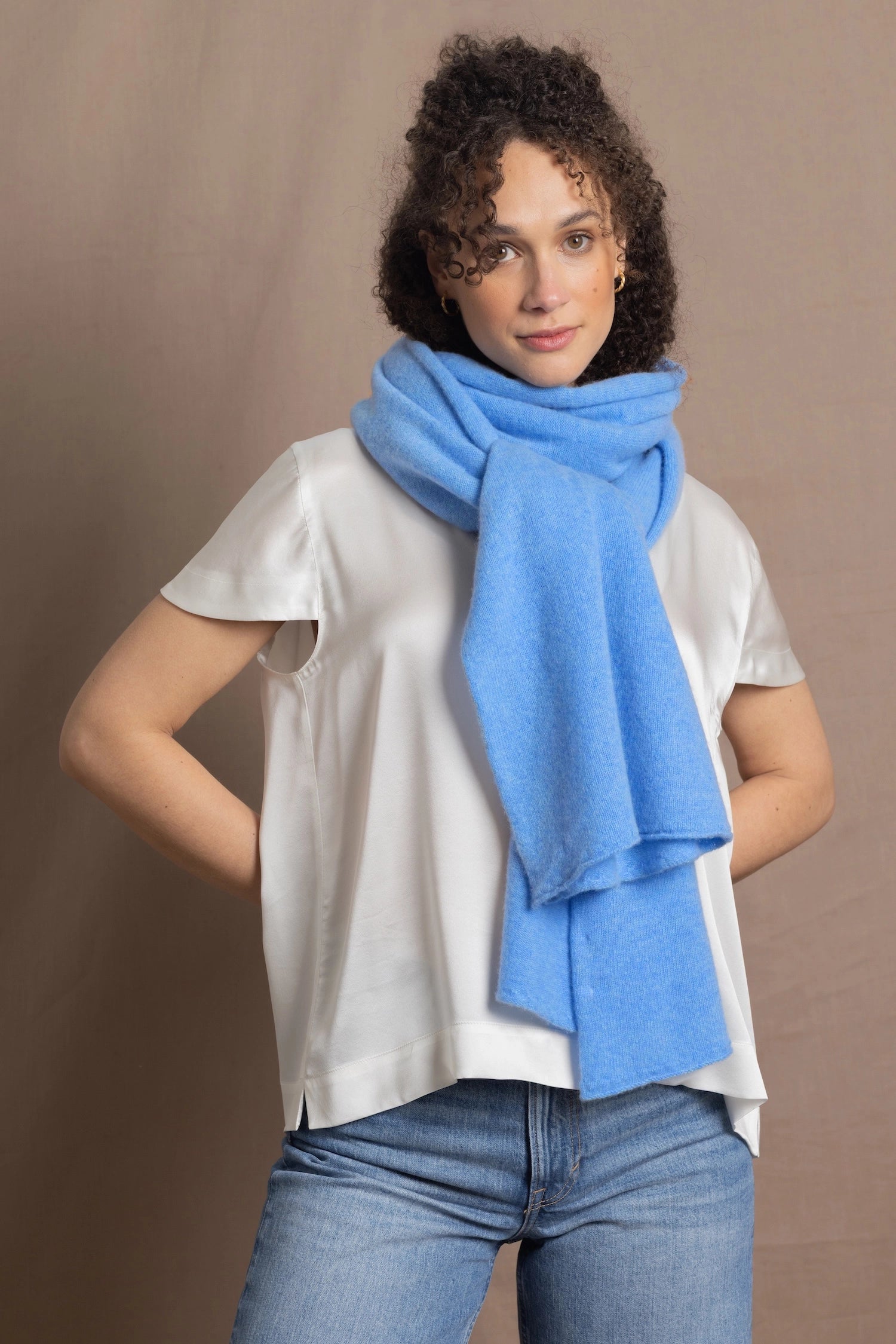 Lady wears luxurious cashmere wrap scarf in cerulean sky blue