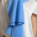 Lady wears luxurious cashmere wrap scarf in cerulean sky blue