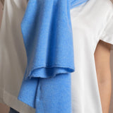 Lady wears luxurious cashmere wrap scarf in cerulean sky blue