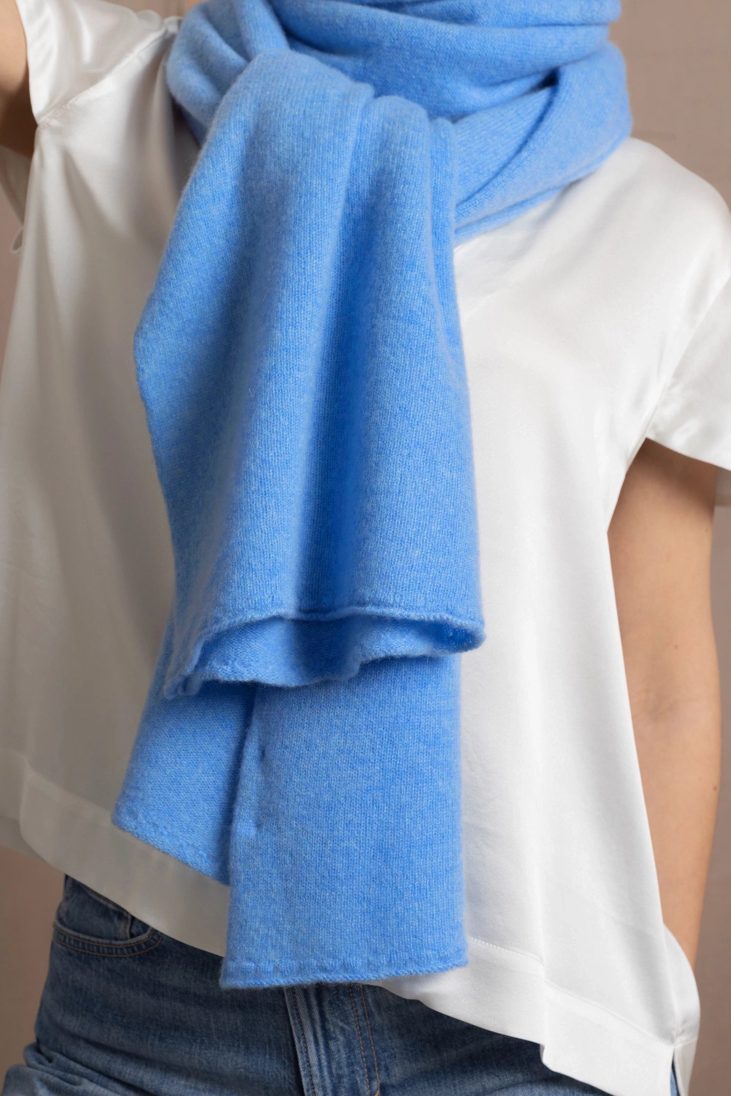 Lady wears luxurious cashmere wrap scarf in cerulean sky blue