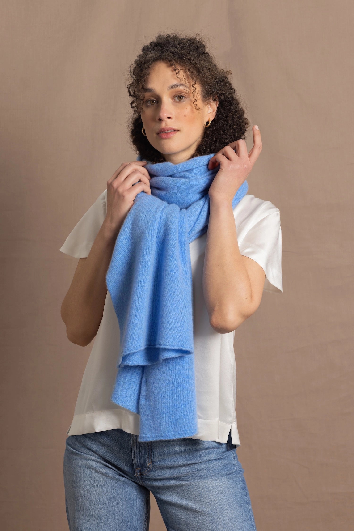 Lady wears luxurious cashmere wrap scarf in cerulean sky blue