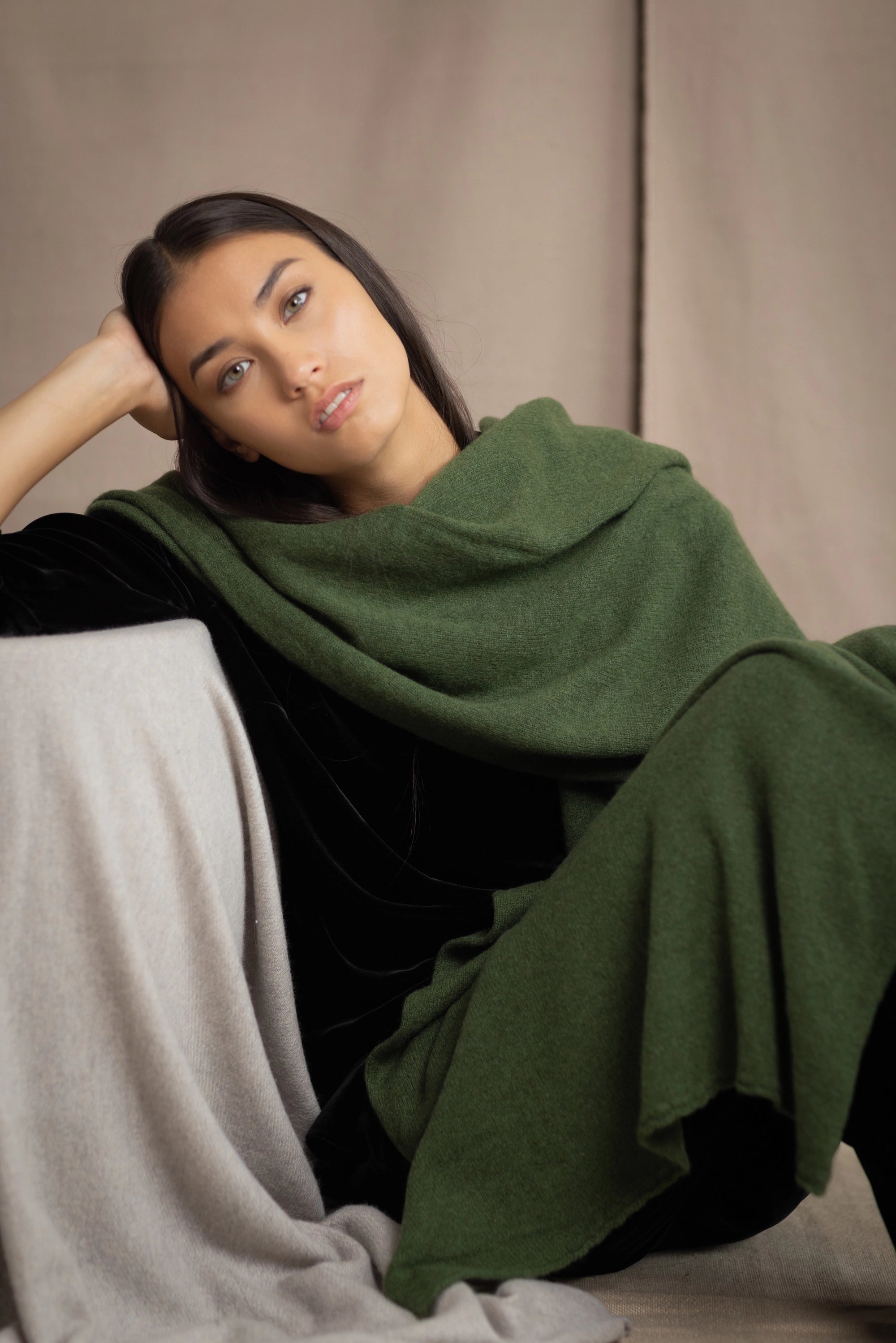 a woman wearing a large cashmere wrap shawl in green over black silk velvet clothing