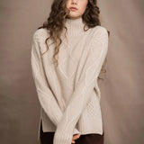 A woman wears a hand knit Irish 100% Cashmere Aran Sweater with Turtleneck in cream beige colour