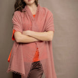 a woman wears a lightweight cashmere shawl cardigan in a dusty pink colour by Irish brand Madigan