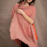 a woman wears a lightweight cashmere shawl cardigan in a dusty pink colour by Irish brand Madigan