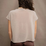 a woman wears a beige cashmere tee with silk trousers in chocolate brown