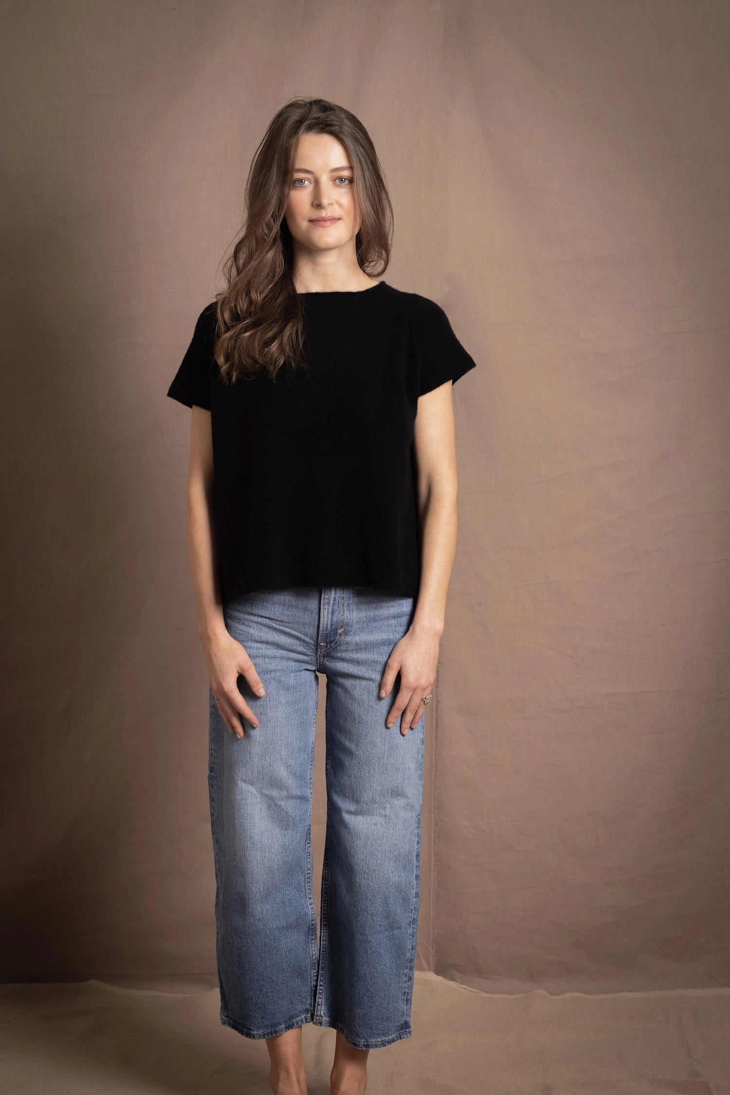 lady standing with 100% cashmere tee short sleeve sweater in black