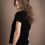lady standing with 100% cashmere tee short sleeve sweater in black