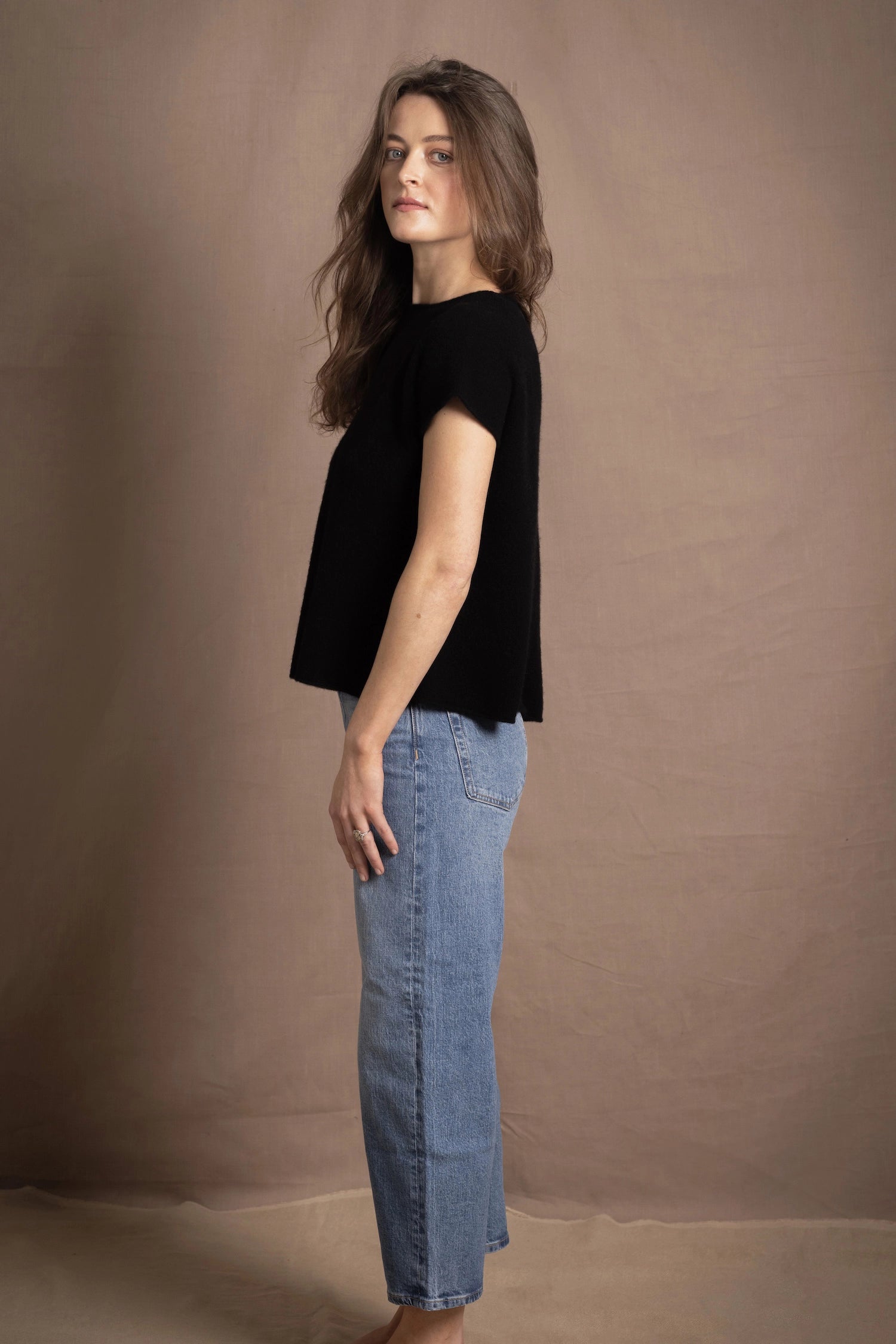 lady standing with 100% cashmere tee short sleeve sweater in black