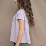 a woman wears a 100% pure cashmere tee sweater in light purple by Irish brand Madigan Cashmere