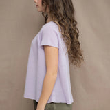 a woman wears a 100% pure cashmere tee sweater in light purple by Irish brand Madigan Cashmere