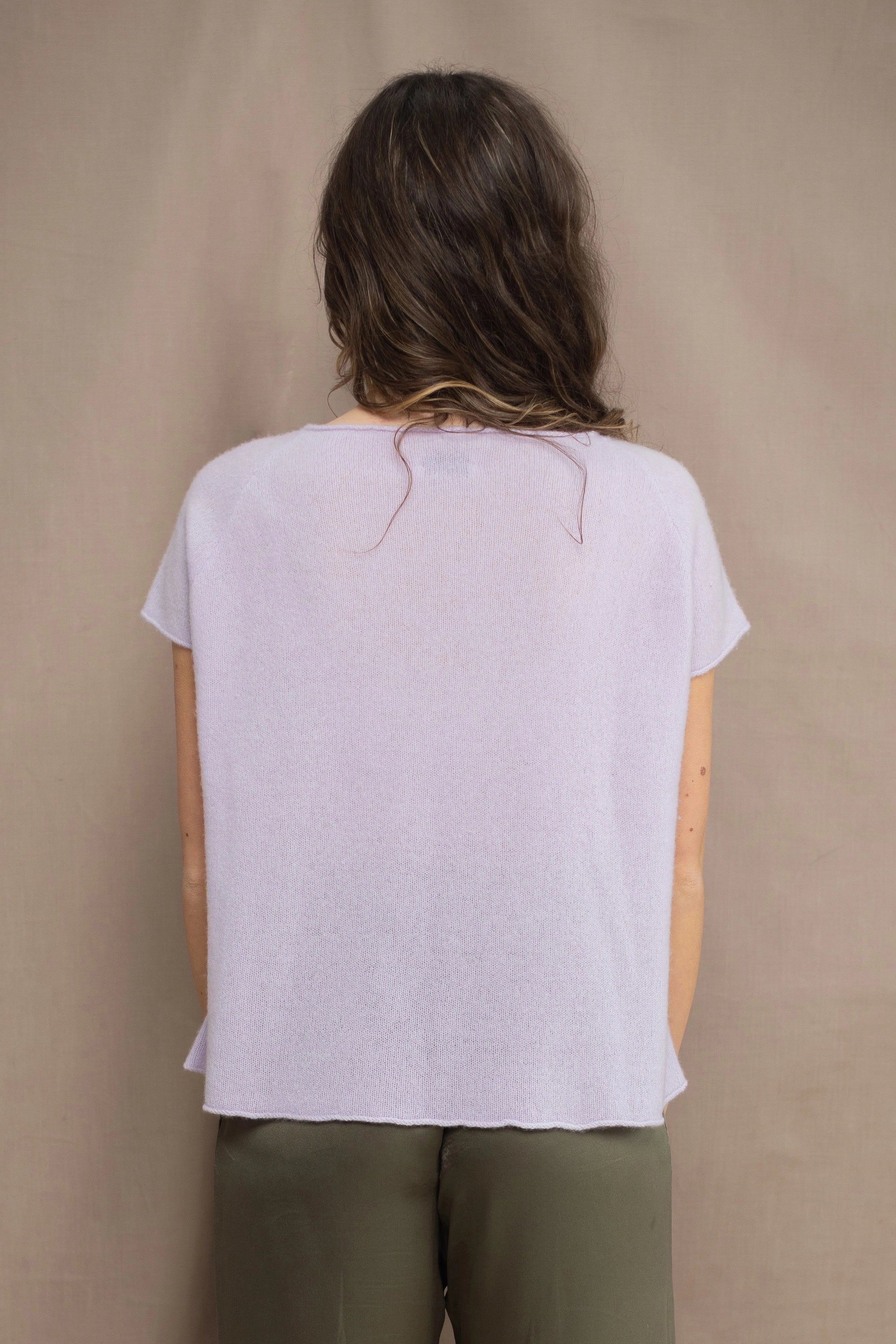 a woman wears a 100% pure cashmere tee sweater in light purple by Irish brand Madigan Cashmere