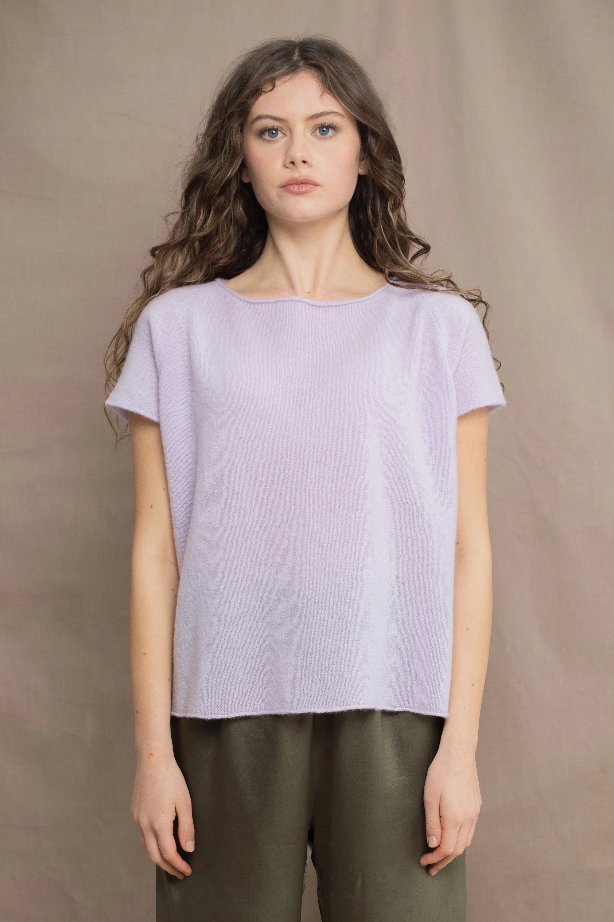 a woman wears a 100% pure cashmere tee sweater in light purple by Irish brand Madigan Cashmere