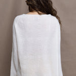 a woman wears a pure 100% cashmere sweater jumper in white over yellow silk trousers