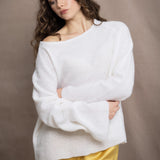 a woman wears a pure 100% cashmere sweater jumper in white over yellow silk trousers