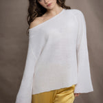 a woman wears a pure 100% cashmere sweater jumper off the shoulder in white over yellow silk trousers