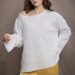 a woman wears a pure 100% cashmere sweater jumper in white over yellow silk trousers