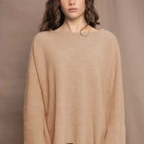 a woman wears a pure 100% cashmere sweater jumper in sand beige colour