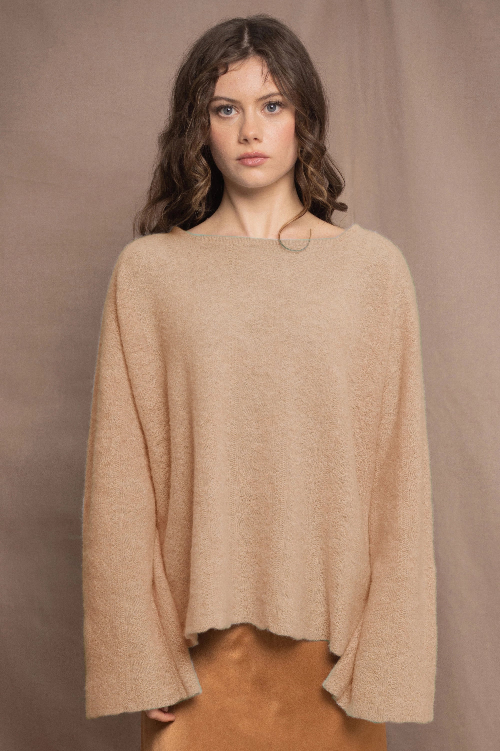 a woman wears a pure 100% cashmere sweater jumper in sand beige colour