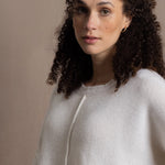 A woman wears an oversized 100% cashmere sweater in Ivory 