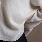 Close up details of a cashmere sweater in ivory