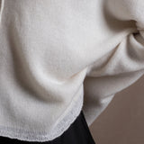 Close up details of a cashmere sweater in ivory