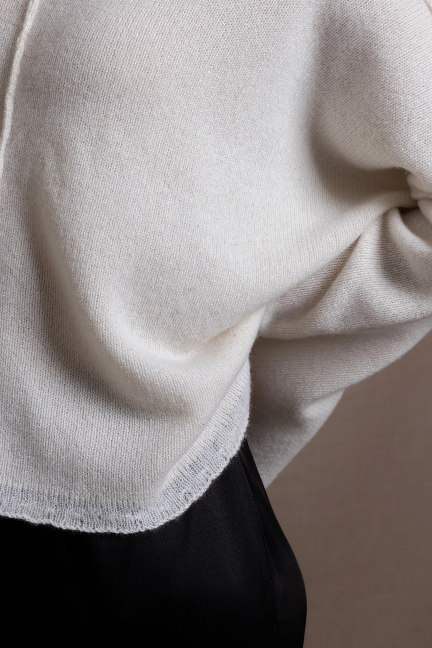 Close up details of a cashmere sweater in ivory