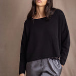 a woman wears a 100% Cashmere Cropped Oversized Sweater in Black by Irish brand Madigan Cashmere
