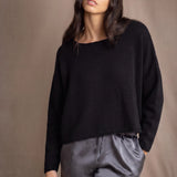a woman wears a 100% Cashmere Cropped Oversized Sweater in Black by Irish brand Madigan Cashmere