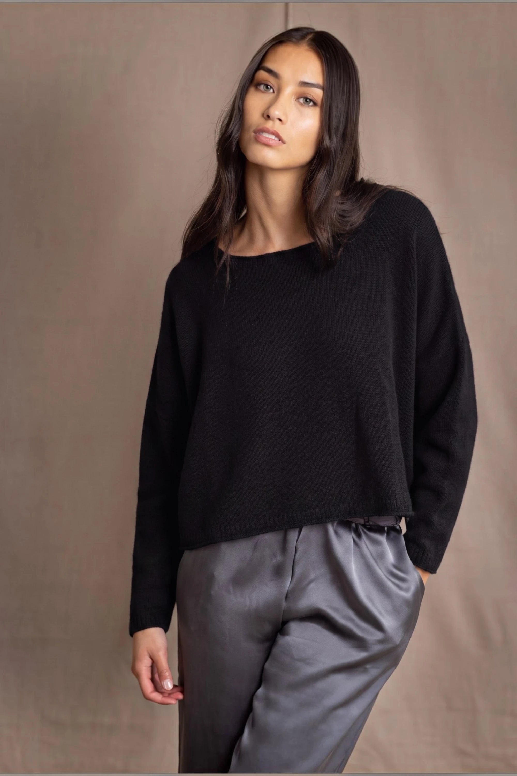 a woman wears a 100% Cashmere Cropped Oversized Sweater in Black by Irish brand Madigan Cashmere