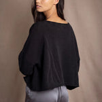 a woman wears a 100% Cashmere Cropped Oversized Sweater in Black by Irish brand Madigan Cashmere
