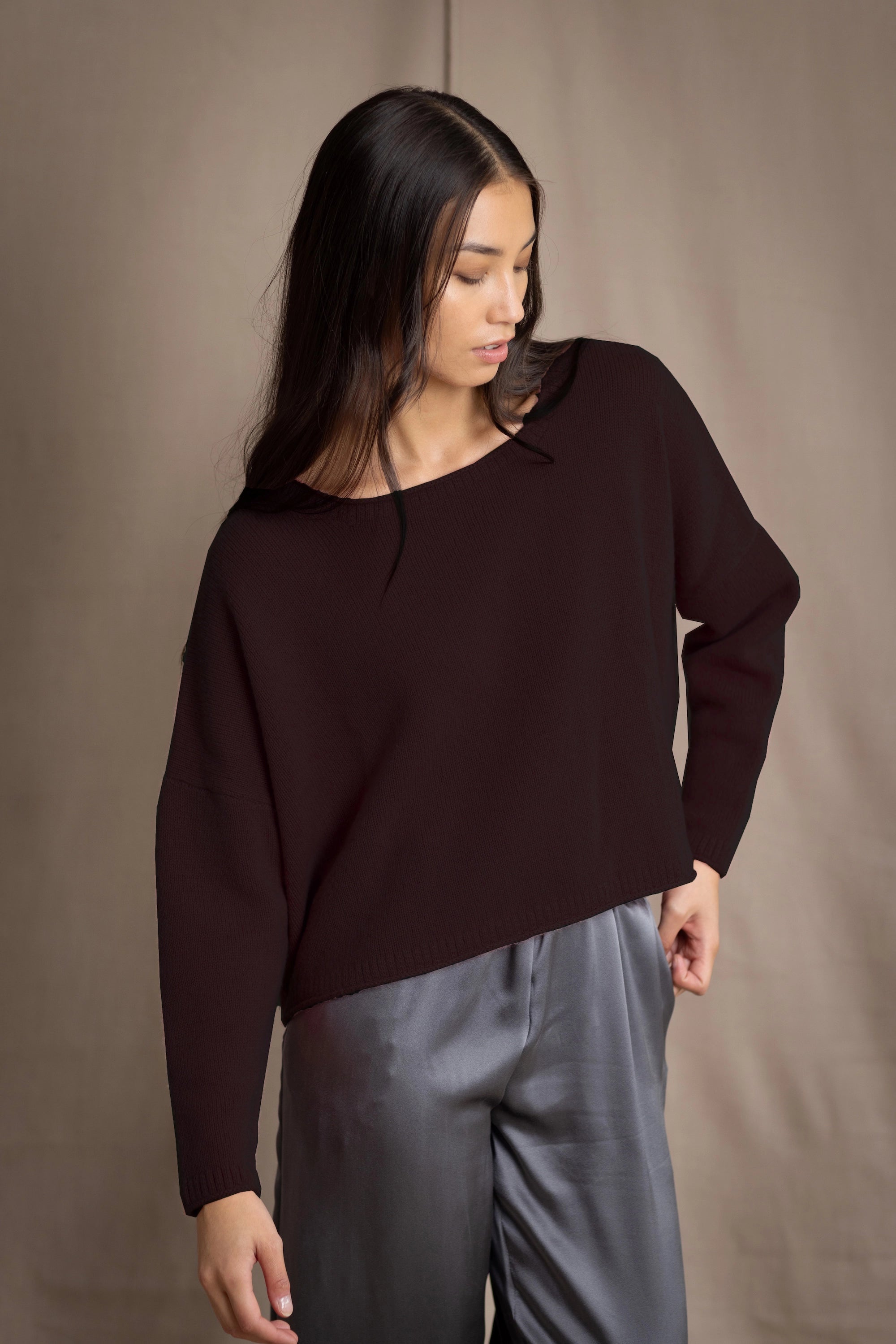 a woman wearing a cropped cashmere sweater in dark brown