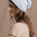 lady wears luxury cashmere beanie hat in pale blue